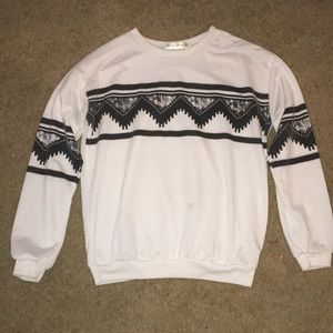 White sweater with gray, black, and white design.